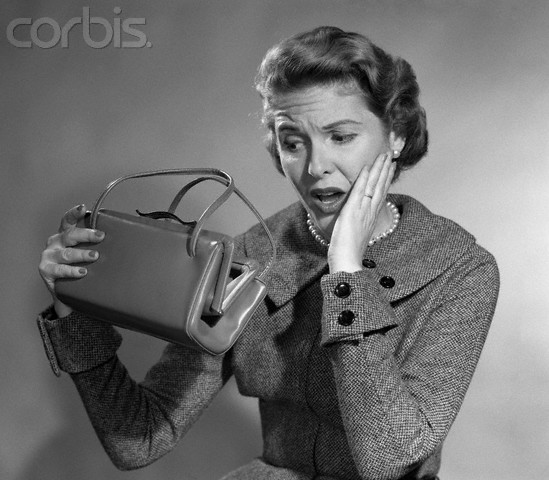 1950s Woman With Exaggerated Expression Hand On Face Looking Inside Her Purse